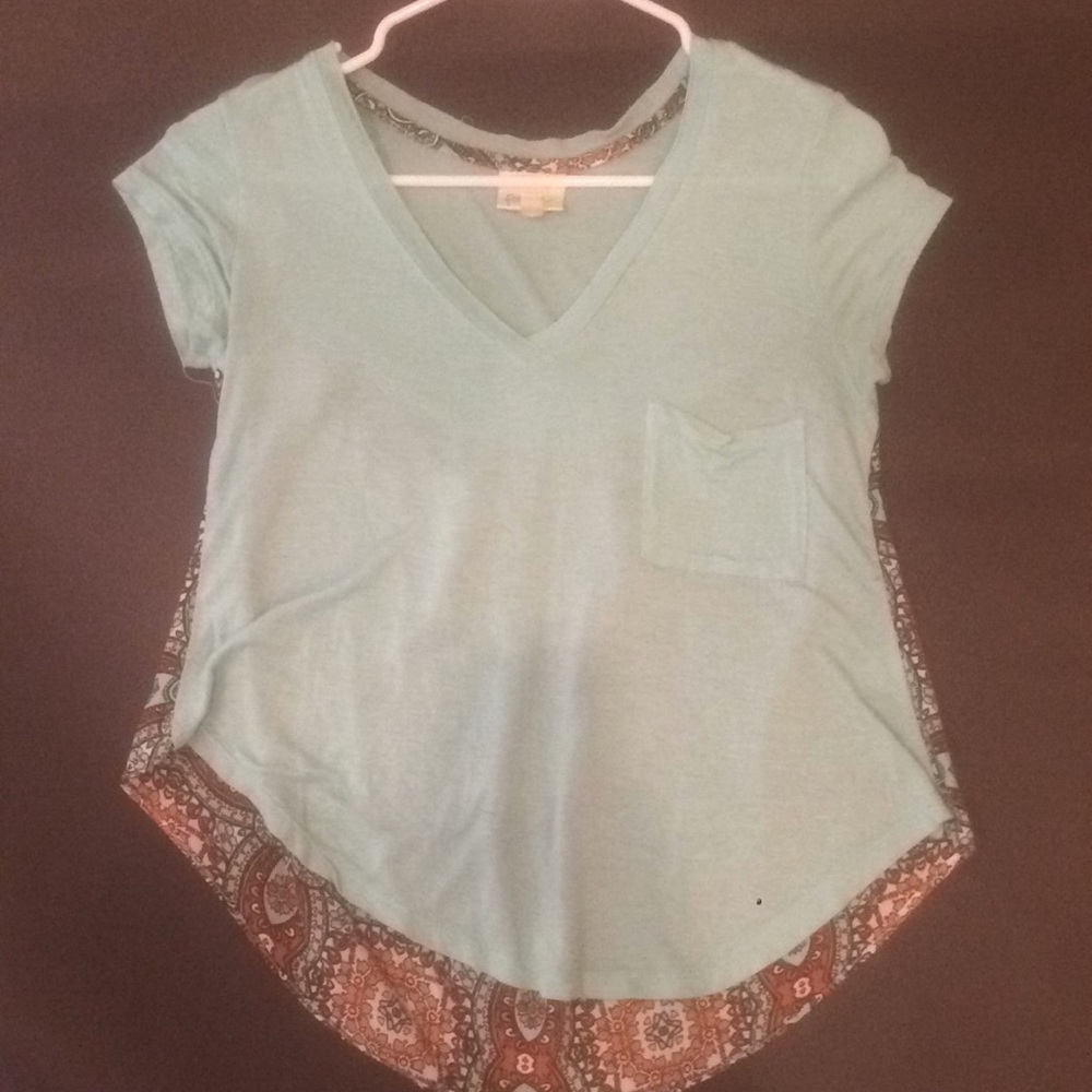 Blue shirt with a burnt orange print on the back.